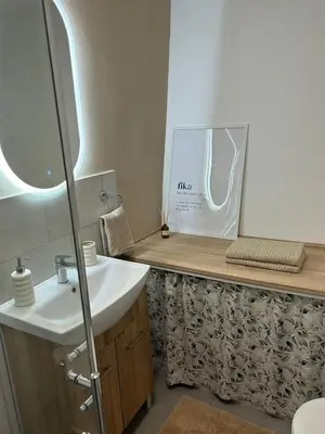 a bathroom with a sink and a mirror at The BeeHouse, Nature stay in Šempeter v Savinjski Dolini