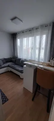 a living room with a couch and a table at URBAN HARMONY APARTMENT Maribor in Maribor