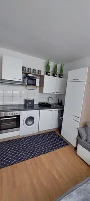 a kitchen with white cabinets and a sink at URBAN HARMONY APARTMENT Maribor in Maribor