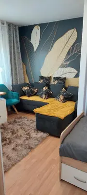 a living room with two beds and a couch at URBAN HARMONY APARTMENT Maribor in Maribor