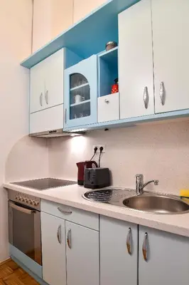 a kitchen with white cabinets and a sink at Ljubljana Center Apartments in Ljubljana