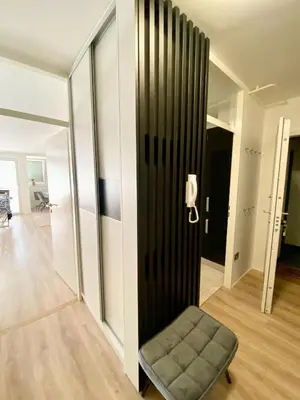 a chair in a room with a black wall at Black & White Hideaway with garage in Ljubljana