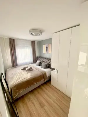 a bedroom with a bed and white cabinets at Black & White Hideaway with garage in Ljubljana