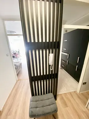 a chair in a room with a black wall at Black & White Hideaway with garage in Ljubljana