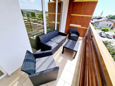 a balcony with two chairs and a table at Apartmaji PANONIA 