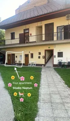 a large house with flowers in the yard at Neptun apartment in Ljubljana