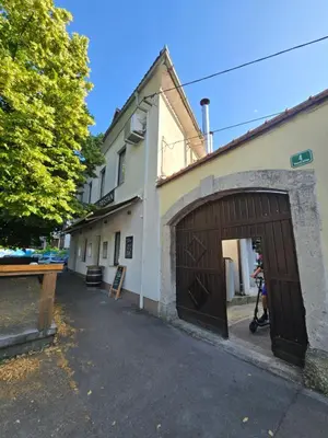 a building with a large wooden garage door at Neptun apartment in Ljubljana