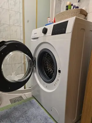 a washing machine sitting next to a dryer at Neptun apartment in Ljubljana