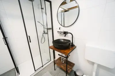 a bathroom with a sink and a mirror at Cozy Alpine House in Gozd Martuljek