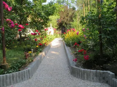 a path through a garden filled with flowers at Studio Lipa in Maribor