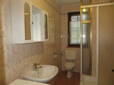 a bathroom with a sink and a toilet at Sobe Orešje in Črniče