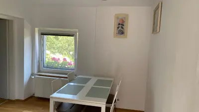 a white room with a table and a window at Semper Liberi in Maribor