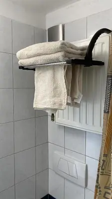 a group of towels on a shelf in a bathroom at Semper Liberi in Maribor