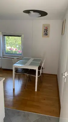 a table and chairs in a room with a window at Semper Liberi in Maribor