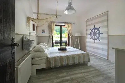 a bedroom with a bed with a nautical sign on the wall at Villa Noiram - Your dream Getaway in Nature in Senožeče