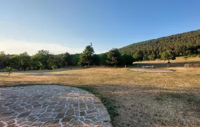 a stone walkway in a field with a picnic table at Villa Noiram - Your dream Getaway in Nature in Senožeče
