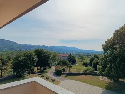 a view from the balcony of a house with mountains in the background at Počitniška hiša Kapitanovše in Ajdovščina