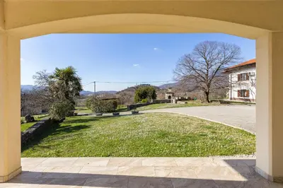 an archway with a view of a yard at Počitniška hiša Kapitanovše in Ajdovščina