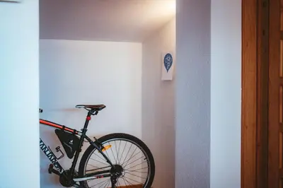 a bike leaning against a wall in a room at Apartma Frigidum in Vipava