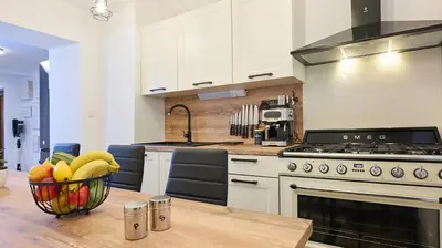 a kitchen with a bowl of fruit on a table at Vista Larix Chalet in Ljubno