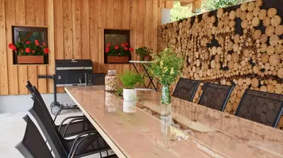 a conference room with a table and chairs and a wall of wood at Vista Larix Chalet in Ljubno