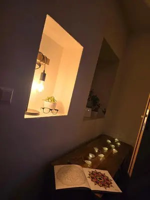 a room with a mirror and a table with a book at Vista Larix Chalet in Ljubno