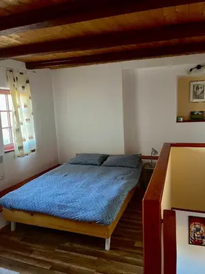 a bedroom with a bed with a blue blanket at Apartma Gasa in Brežice