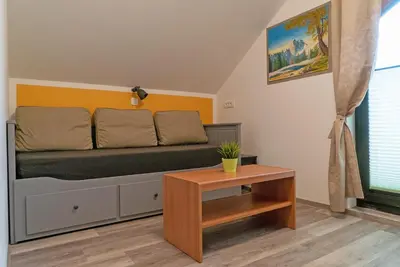 a living room with a couch and a table at Apartments Helena Kranjska Gora in Kranjska Gora