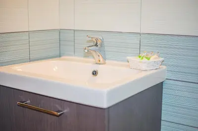 a sink with a faucet in a bathroom at Apartments Helena Kranjska Gora in Kranjska Gora