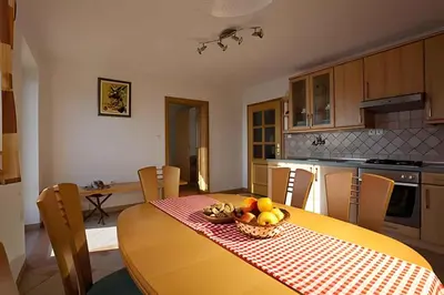 a kitchen with a table with a bowl of fruit on it at Holiday home in Otocec - Kranjska (Krain) 26040 in Otočec