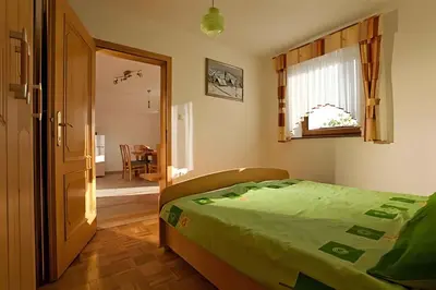 a bedroom with a bed and a window and a table at Holiday home in Otocec - Kranjska (Krain) 26040 in Otočec