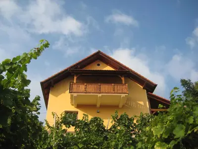 a yellow building with a balcony on top of it at Holiday home in Otocec - Kranjska (Krain) 26040 in Otočec