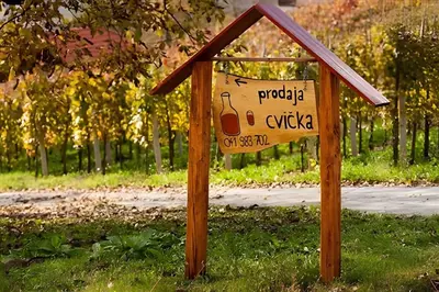 a sign in the grass next to a street at Holiday home in Otocec - Kranjska (Krain) 26040 in Otočec