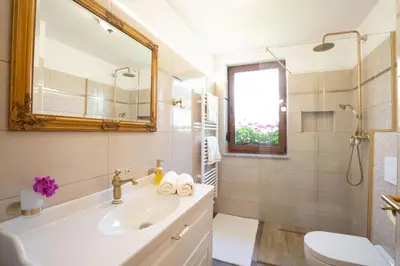 a white bathroom with a sink and a mirror at Aparthotel Hom at Vintgar in Zgornje Gorje