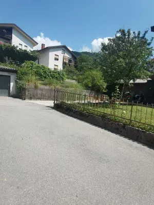 a driveway with a fence in front of a house at Apartma PRI ŠTAJERKI in Most na Soči