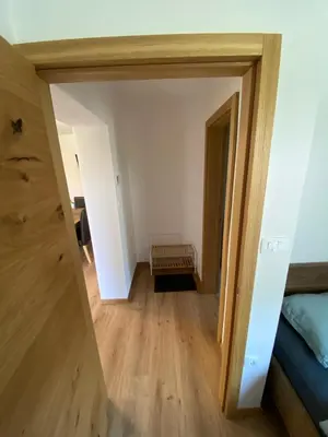 a view from the hallway into a room with a bed at Apartma PRI ŠTAJERKI in Most na Soči