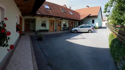 a car parked in the driveway of a house at Apartments Šuster in Stari Trg ob Kolpi