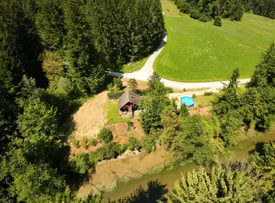 an aerial view of a house on an island in a river at WoodHouseDream Jakuzzi in Nazarje