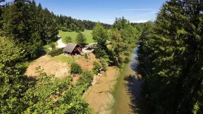 an aerial view of a house next to a river at WoodHouseDream Jakuzzi in Nazarje