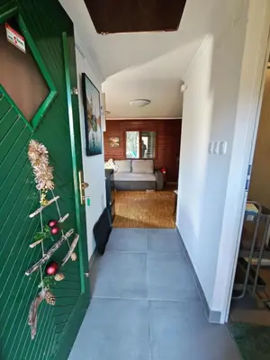 a hallway leading to a living room with a couch at WoodHouseDream Jakuzzi in Nazarje
