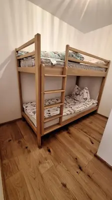 two bunk beds in a room with a wooden floor at Rooms Dreisiebner at the Heart in Zgornja Kungota