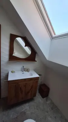 a bathroom with a sink and a skylight at Rooms Dreisiebner at the Heart in Zgornja Kungota