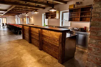 a bar in a restaurant with a wooden wall at Rooms Dreisiebner at the Heart in Zgornja Kungota