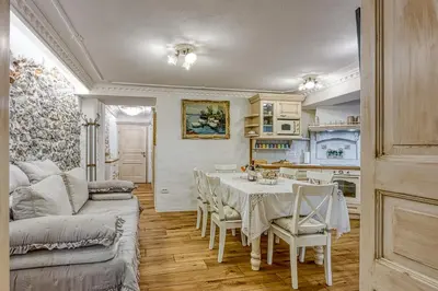 a living room with a table and a kitchen at Royal Garden in Škofja Loka