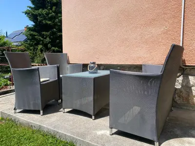 a group of chairs and a table with a vase at Apartma Tatjana in Žirovnica