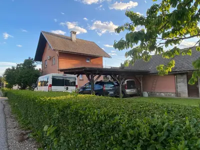 a house with a van parked in front of it at Apartma Tatjana in Žirovnica