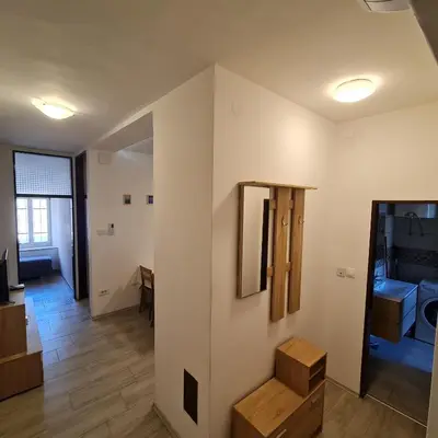 a room with white walls and wooden floors at Josef apartment, CENTER in Solkan