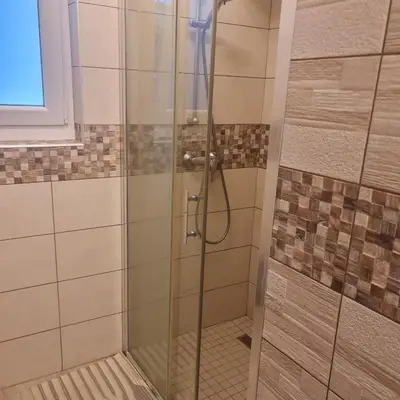 a shower with a glass door in a bathroom at Josef apartment, CENTER in Solkan