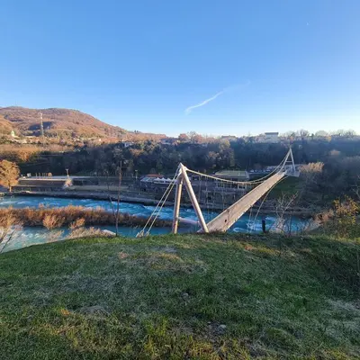 a bridge on top of a hill next to a river at Josef apartment, CENTER in Solkan