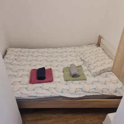 a bed with two pillows on top of it at Josef apartment, CENTER in Solkan